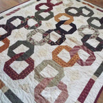 Alternate lay of Fireside Links Lap Quilt showing entire quilt.