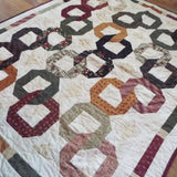 Alternate lay of Fireside Links Lap Quilt showing entire quilt.