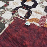 Corner flipped over to show backing for Fireside Links Lap Quilt.