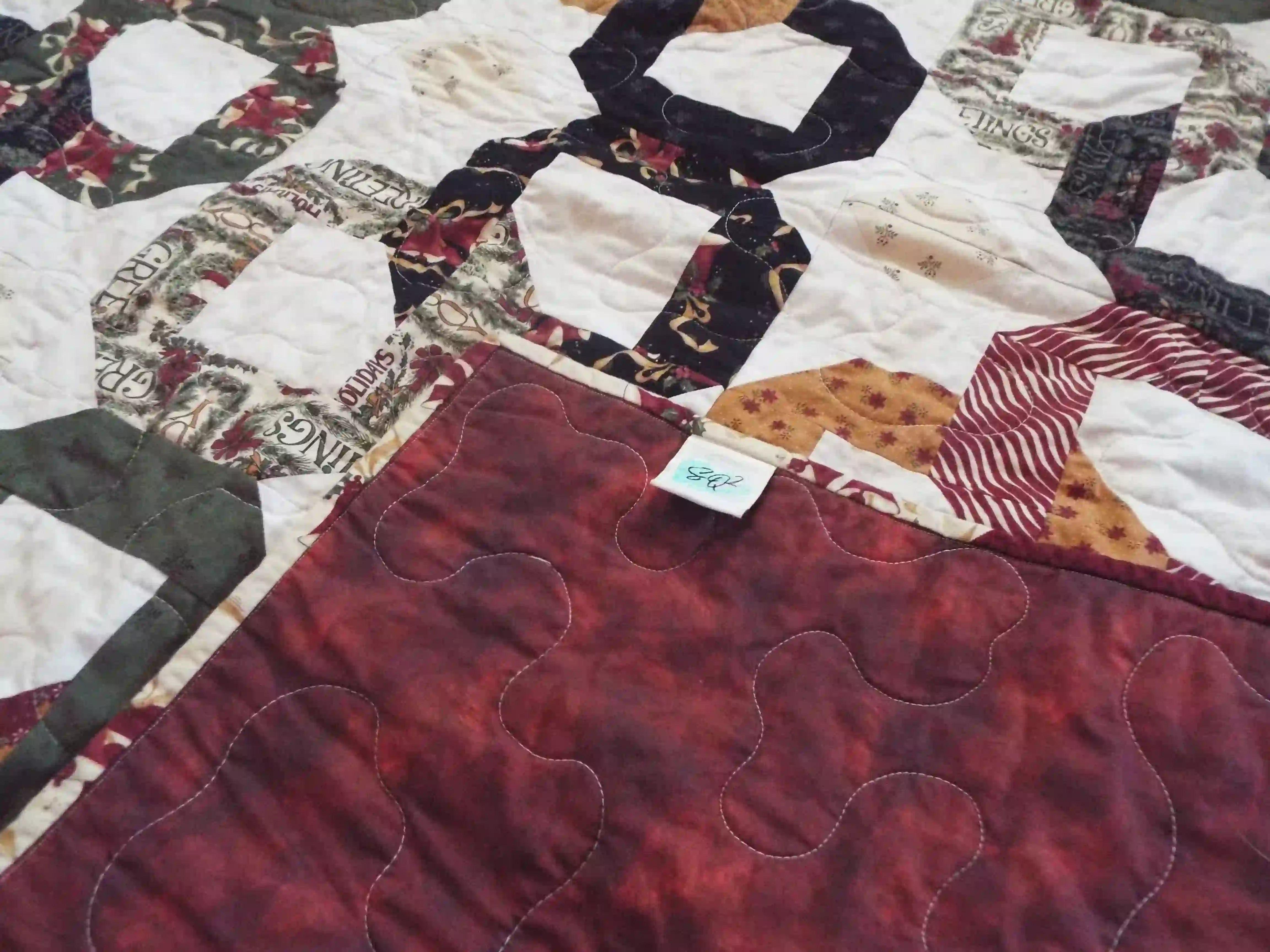 Corner flipped over to show backing for Fireside Links Lap Quilt.