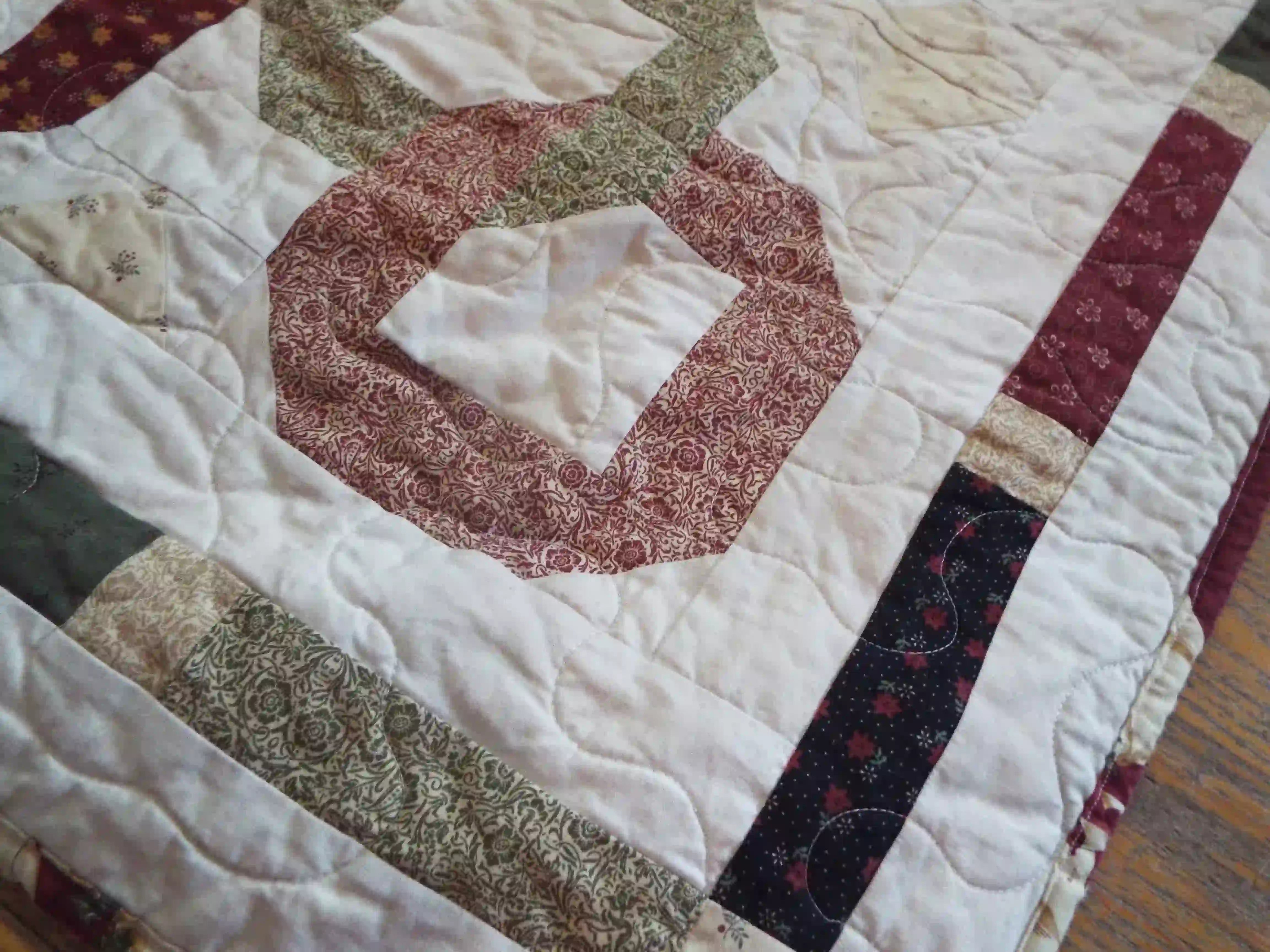 Detail of Fireside Links Lap Quilt showing stitching, pieced border, and binding.