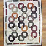 Flat lay of Fireside Links Lap Quilt showing entire quilt.