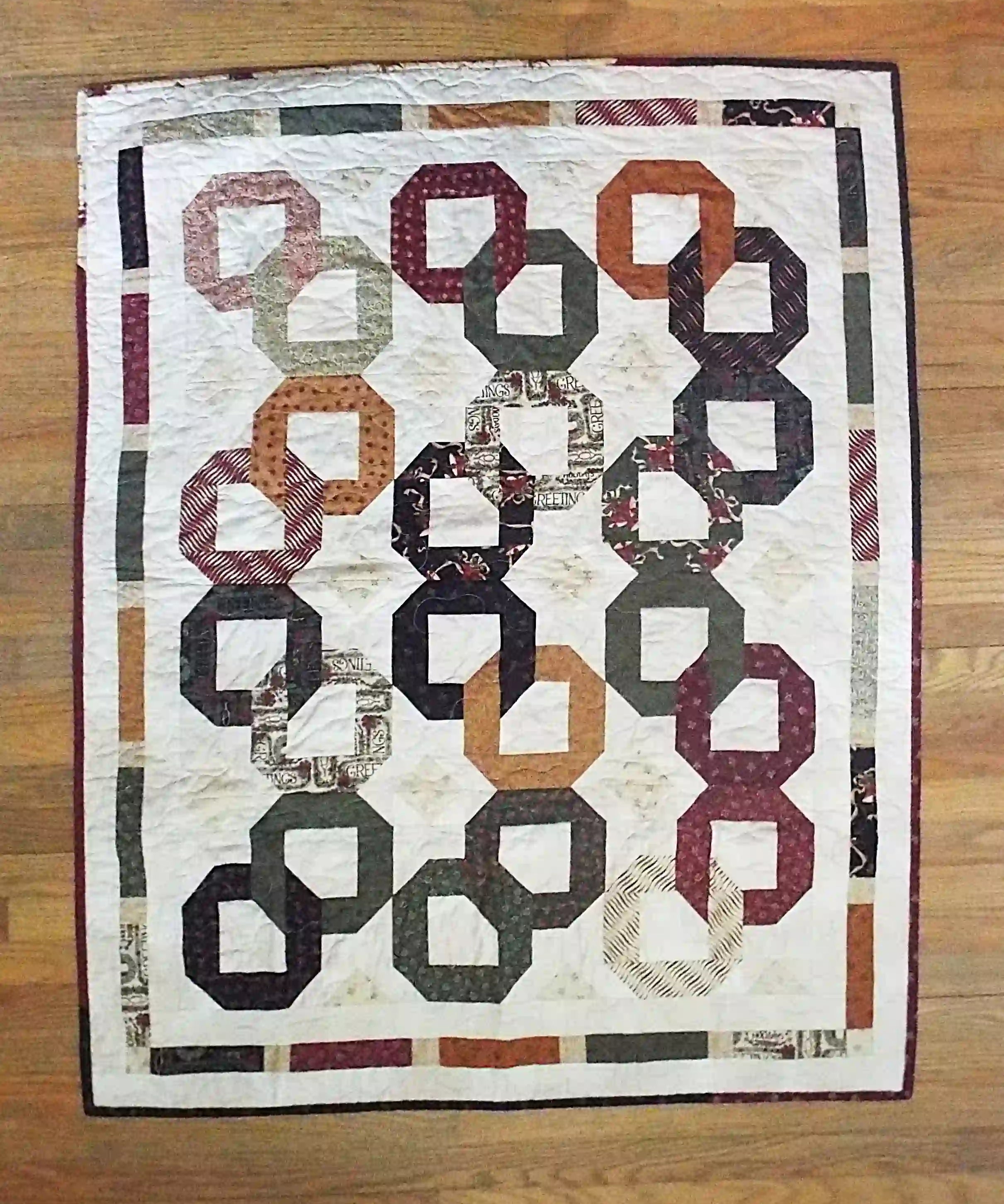 Flat lay of Fireside Links Lap Quilt showing entire quilt.