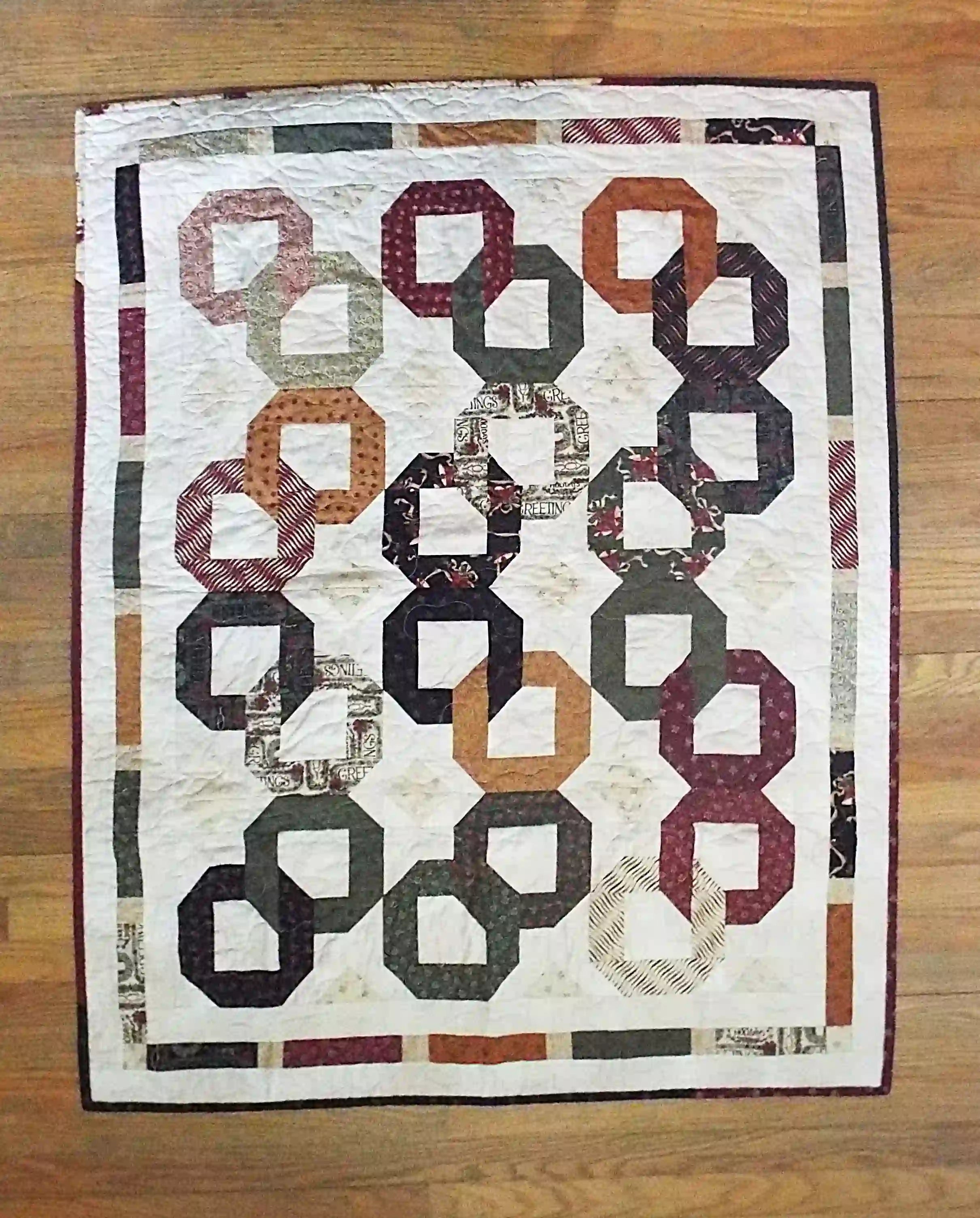 Flat lay of Fireside Links Lap Quilt showing entire quilt.