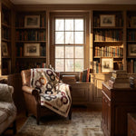 Fireside Links Lap Quilt shown draped over a brown leather chair in a traditional study.