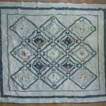 Flat lay of Framed Botanicals Twin Quilt showing entire quilt.