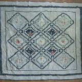 Flat lay of Framed Botanicals Twin Quilt showing entire quilt.
