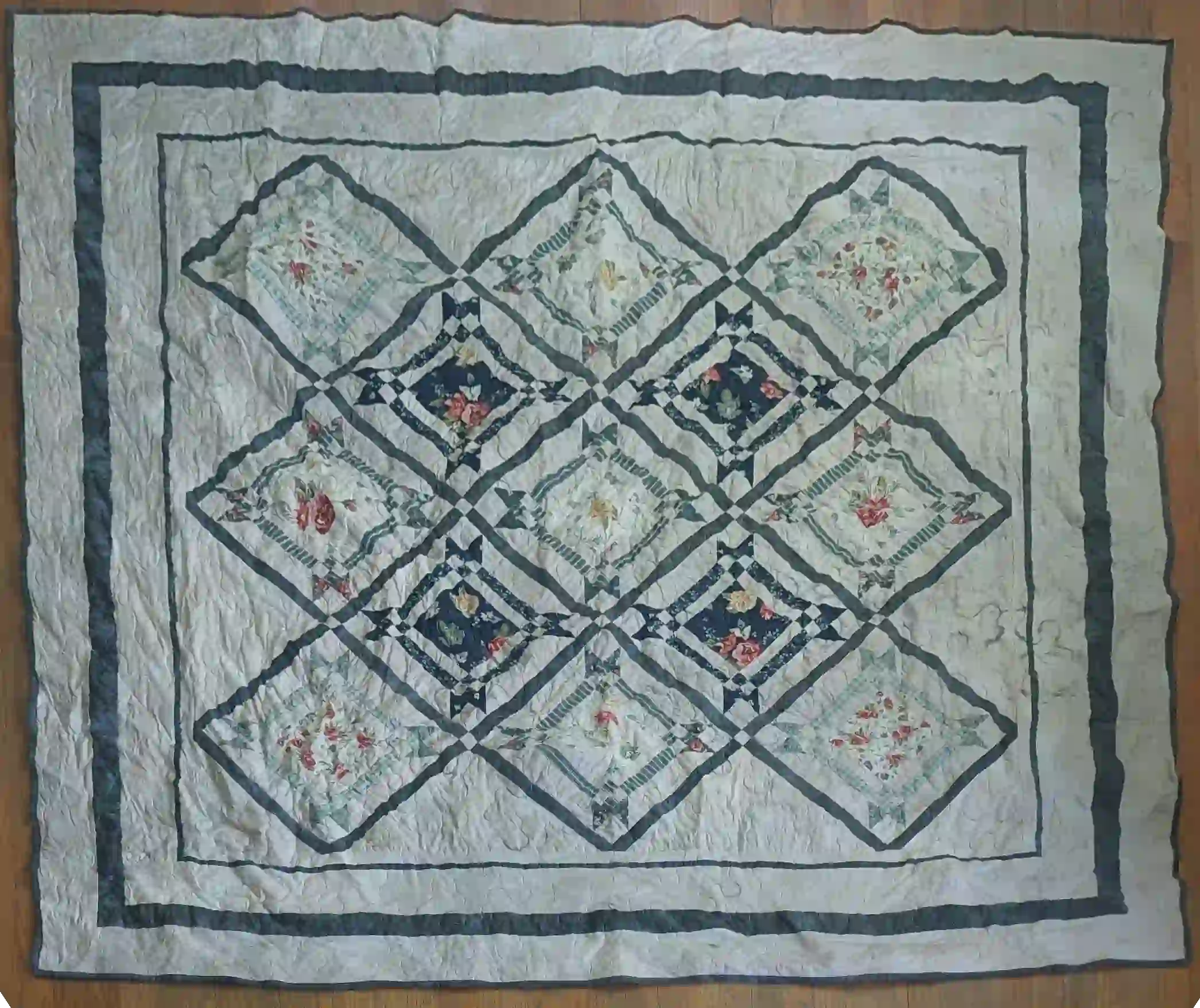 Flat lay of Framed Botanicals Twin Quilt showing entire quilt.