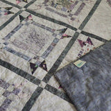 Gathered Correspondence Twin Quilt shown with corner flipped over to see backing.