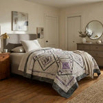 Gathered Correspondence Twin Quilt shown in elegantly simple bedroom.