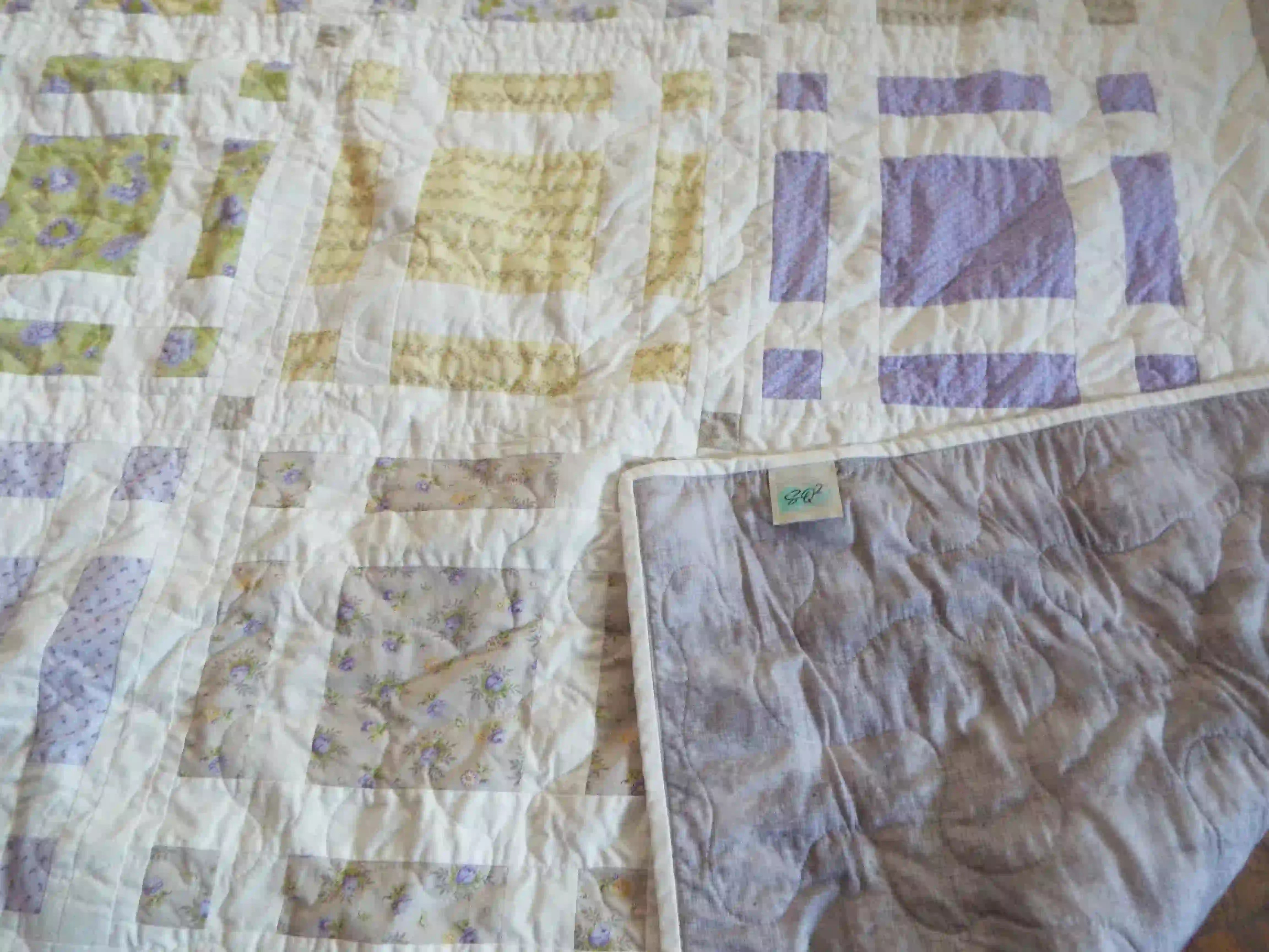 Georgian Garden Queen with corner flipped over to show backing along with quilt stitching detail