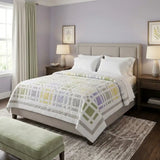 Georgian Garden Queen on an upholstered queen bed in a lavender painted room.