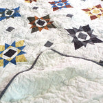 Starry Comfort handmade quilt with the backing flipped to show reverse