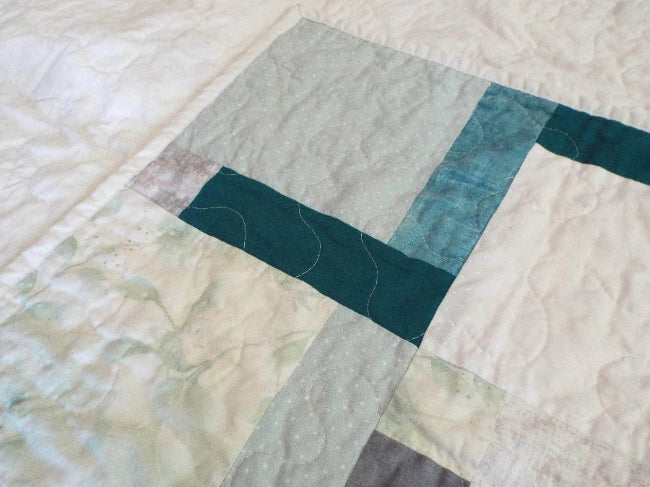 Detail of handmade quilt showing both top and backing