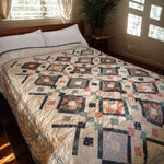 Handmade twin floral quilt shown in a minimally decorated bedroom