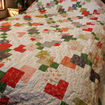View of quilt showing detail in blocks and quilting