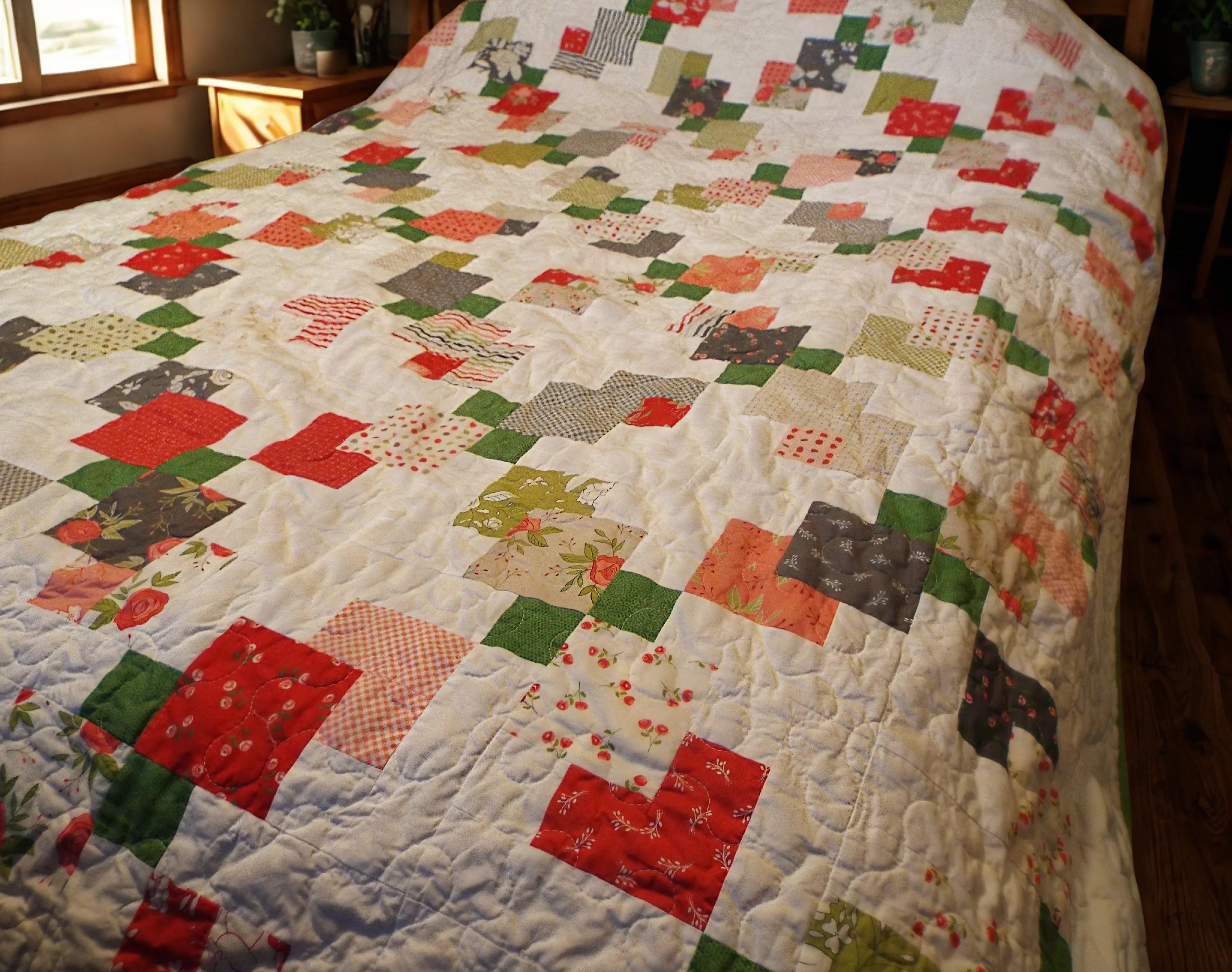 View of quilt showing detail in blocks and quilting