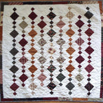 Holiday Heirloom lap quilt shown in its entirety in a flat lay