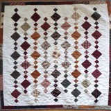 Holiday Heirloom lap quilt shown in its entirety in a flat lay