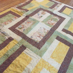 Angled lay of Honeyed Tails showing closer look at quilt top.