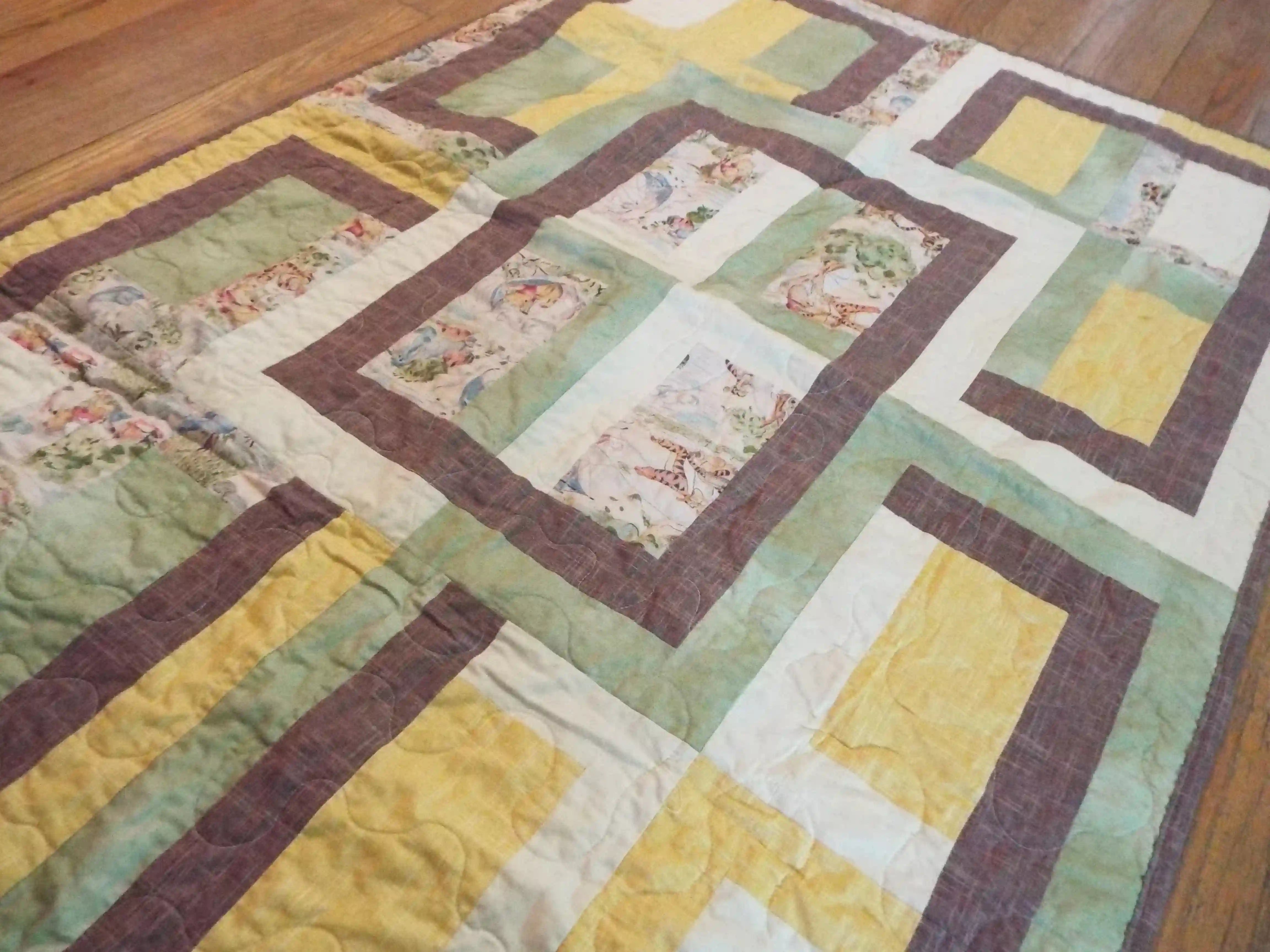 Angled lay of Honeyed Tails showing closer look at quilt top.