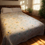 Honeybloom handmade queen quilt with floral patterns in a boho-inspired cozy bedroom