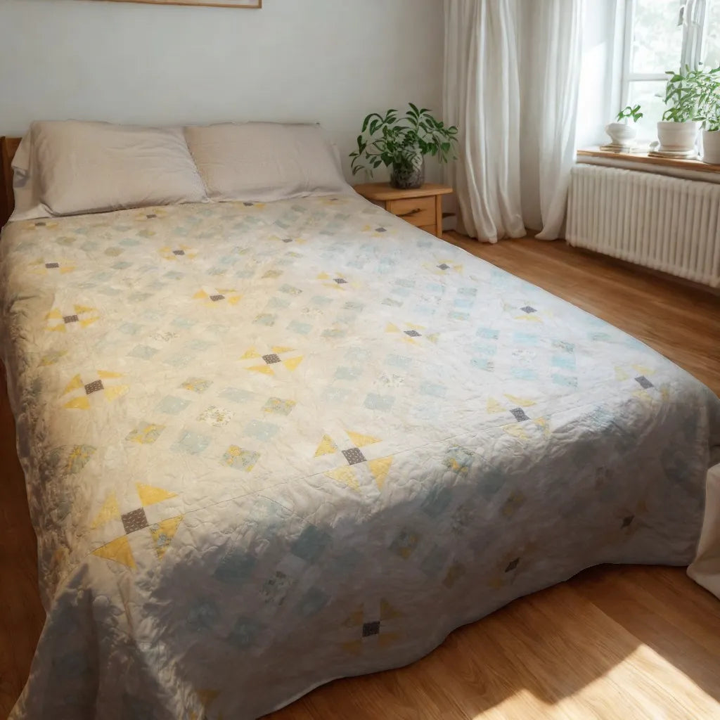 Lightweight cotton queen quilt in aqua floral and honey tones styled in a modern minimalist bedroom