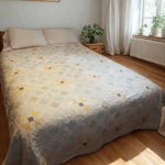 Lightweight cotton queen quilt in aqua floral and honey tones styled in a modern minimalist bedroom