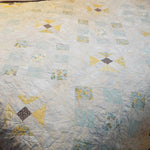 Close-up of freehand quilting on Honeybloom handmade queen quilt