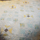 Close-up of freehand quilting on Honeybloom handmade queen quilt
