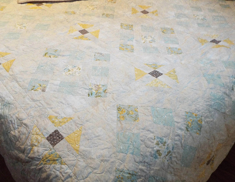 Close-up of freehand quilting on Honeybloom handmade queen quilt