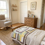 Honeyed Tails Baby Quilt shown folded on a child's bed.