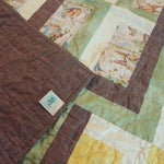 Corner flipped up on Honeyed Tails Baby Quilt to show backing detail.