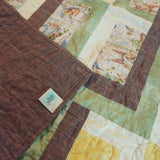 Corner flipped up on Honeyed Tails Baby Quilt to show backing detail.