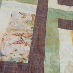 Detail of stitching and fabrics for Honeyed Tails Baby Quilt