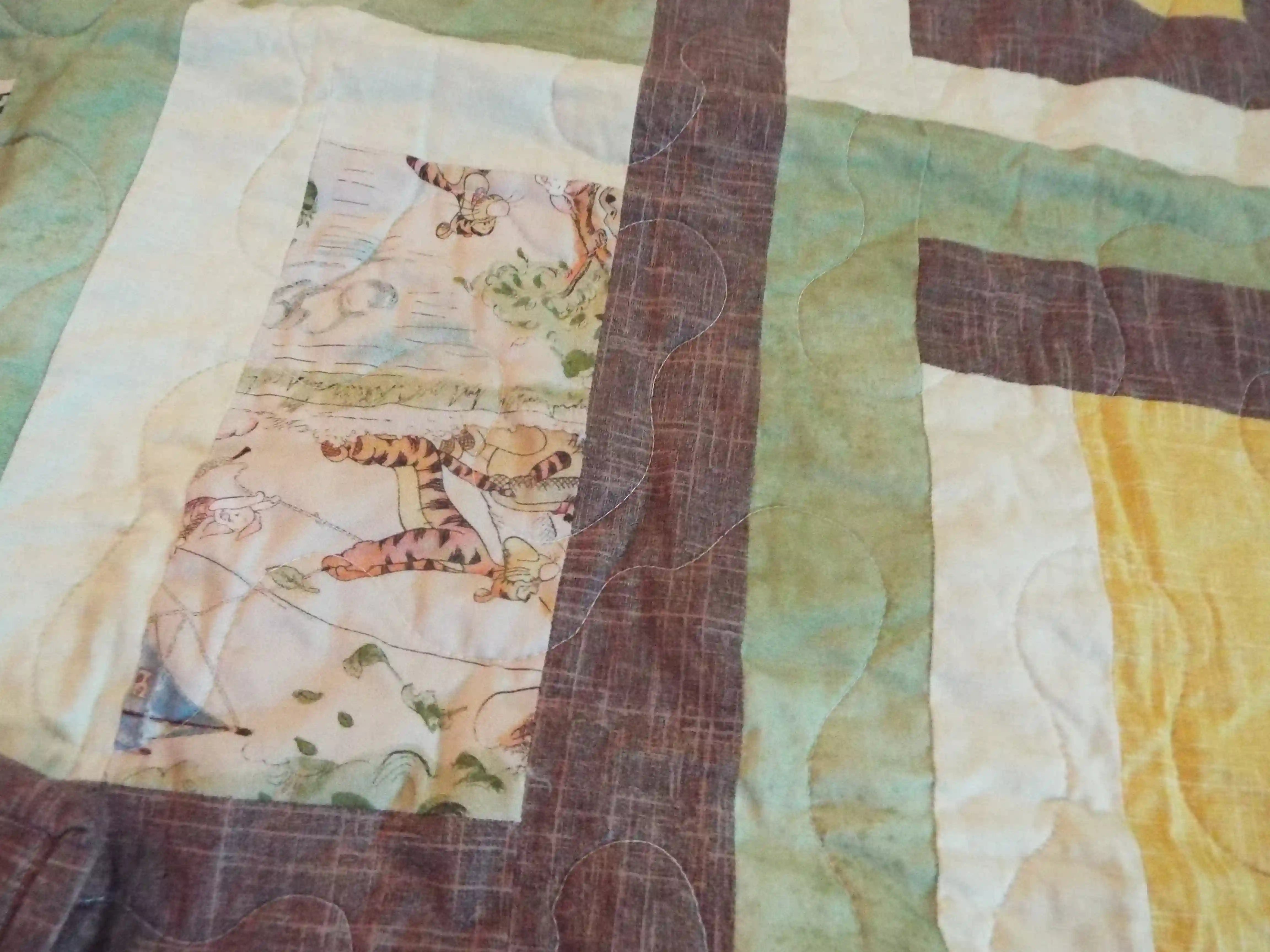 Detail of stitching and fabrics for Honeyed Tails Baby Quilt