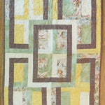 Flat lay of Honeyed Tails Baby Quilt showing entire quilt.