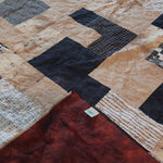 Inkstone King quilt shown with corner flipped up to see backing against quilt top.