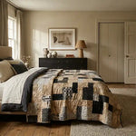 Inkstone King quilt shown in a sophisticated bedroom with black dresser and neutral walls.