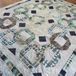 Angled lay of Links to the Past Lap Quilt showing the entire quilt.