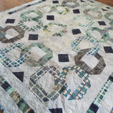 Angled lay of Links to the Past Lap Quilt showing the entire quilt.