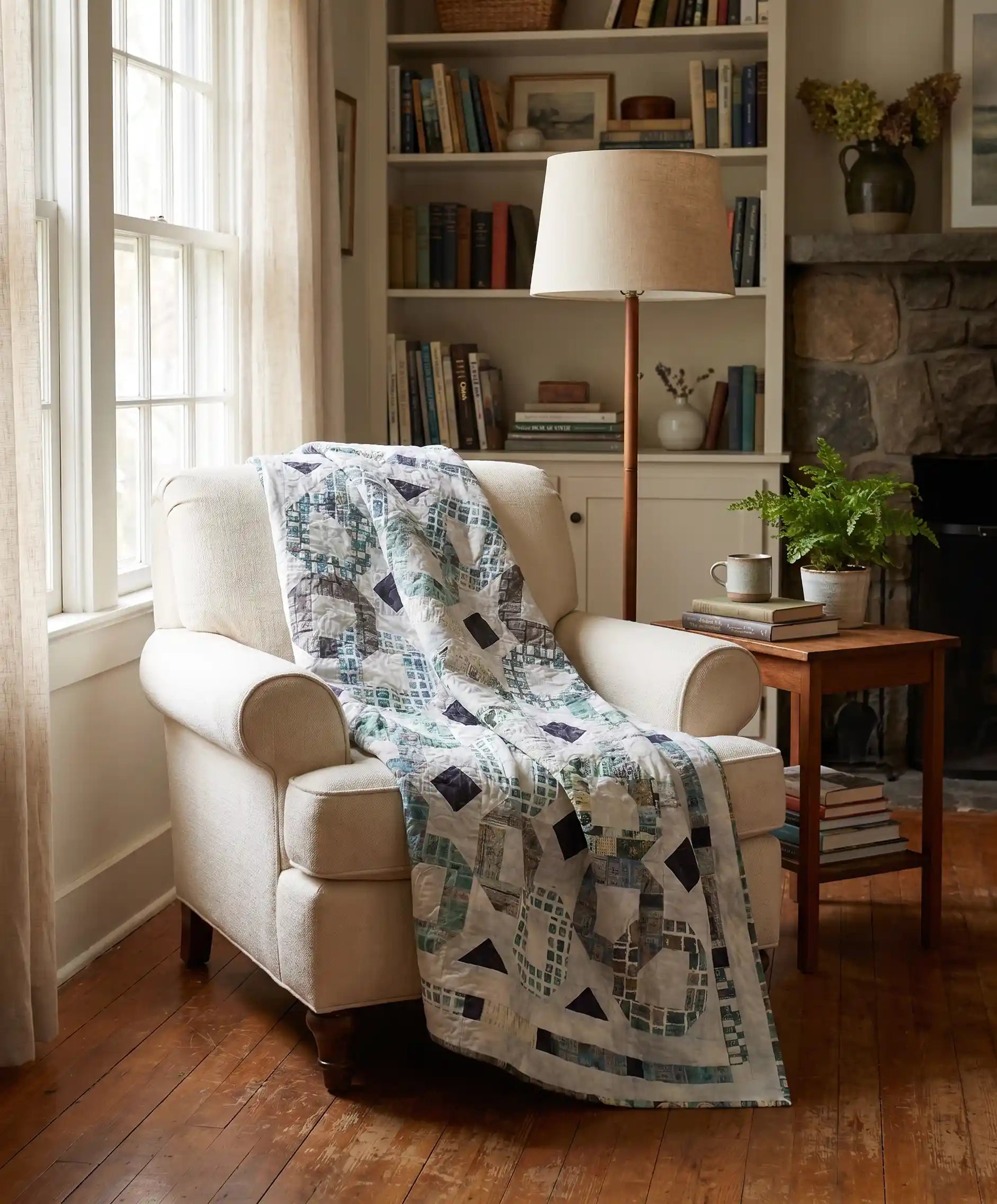 Links to the Past Lap Quilt shown in a corner reading nook of a living room with a stone fireplace and built in bookshelves.