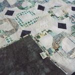 Corner flipped up for Links to the Past Lap Quilt showing backing.