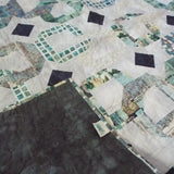 Corner flipped up for Links to the Past Lap Quilt showing backing.