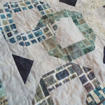 Detail of stitching and fabrics for Links to the Past Lap Quilt.