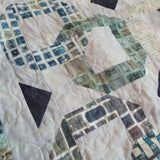 Detail of stitching and fabrics for Links to the Past Lap Quilt.