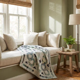 Links to the Past Lap Quilt shown in a minimally styled window seat corner.