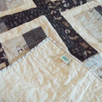 Corner flipped over on Little Framework Baby Quilt to show backing detail.