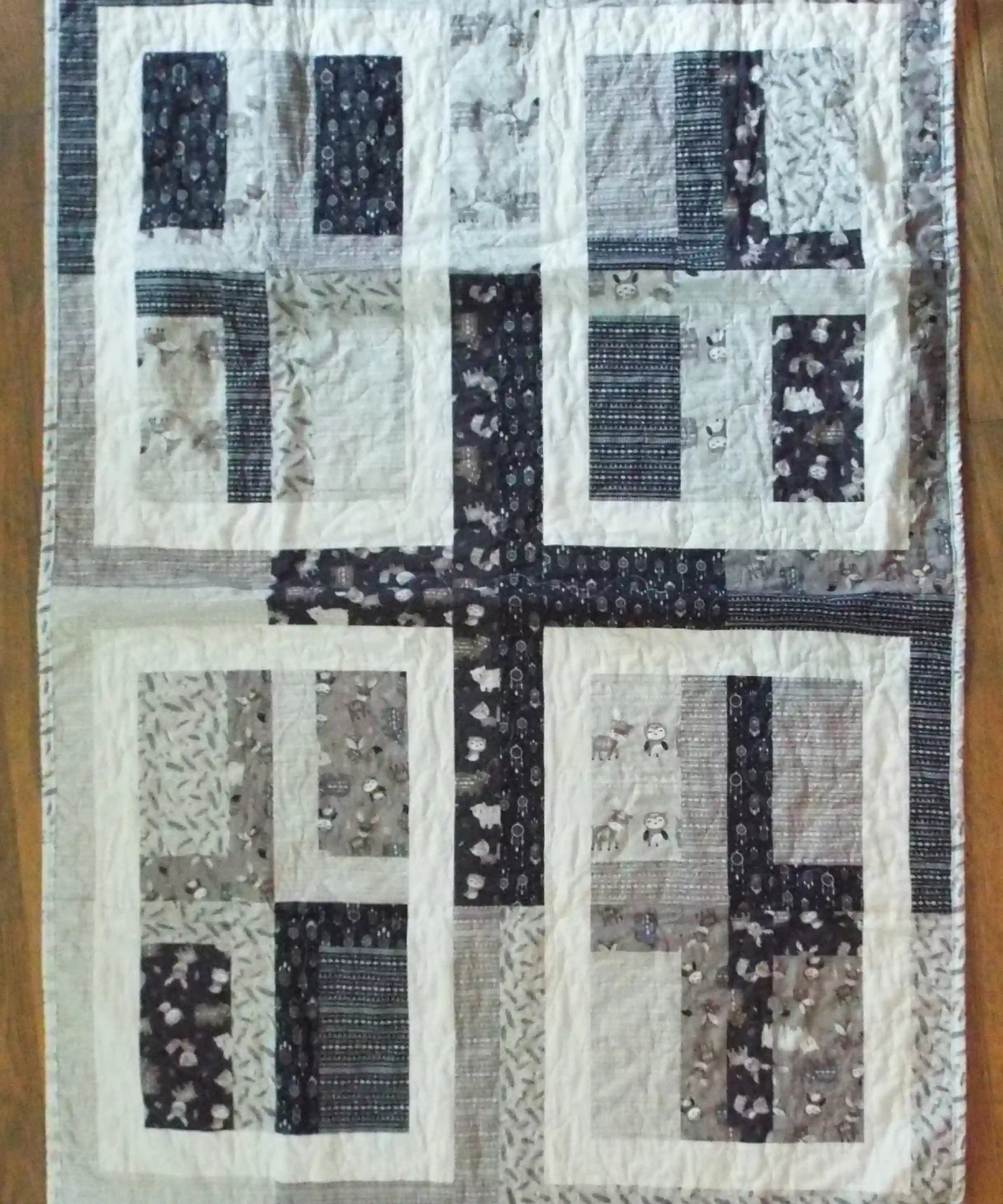 Flat lay of Little Framework Baby Quilt showing entire quilt.