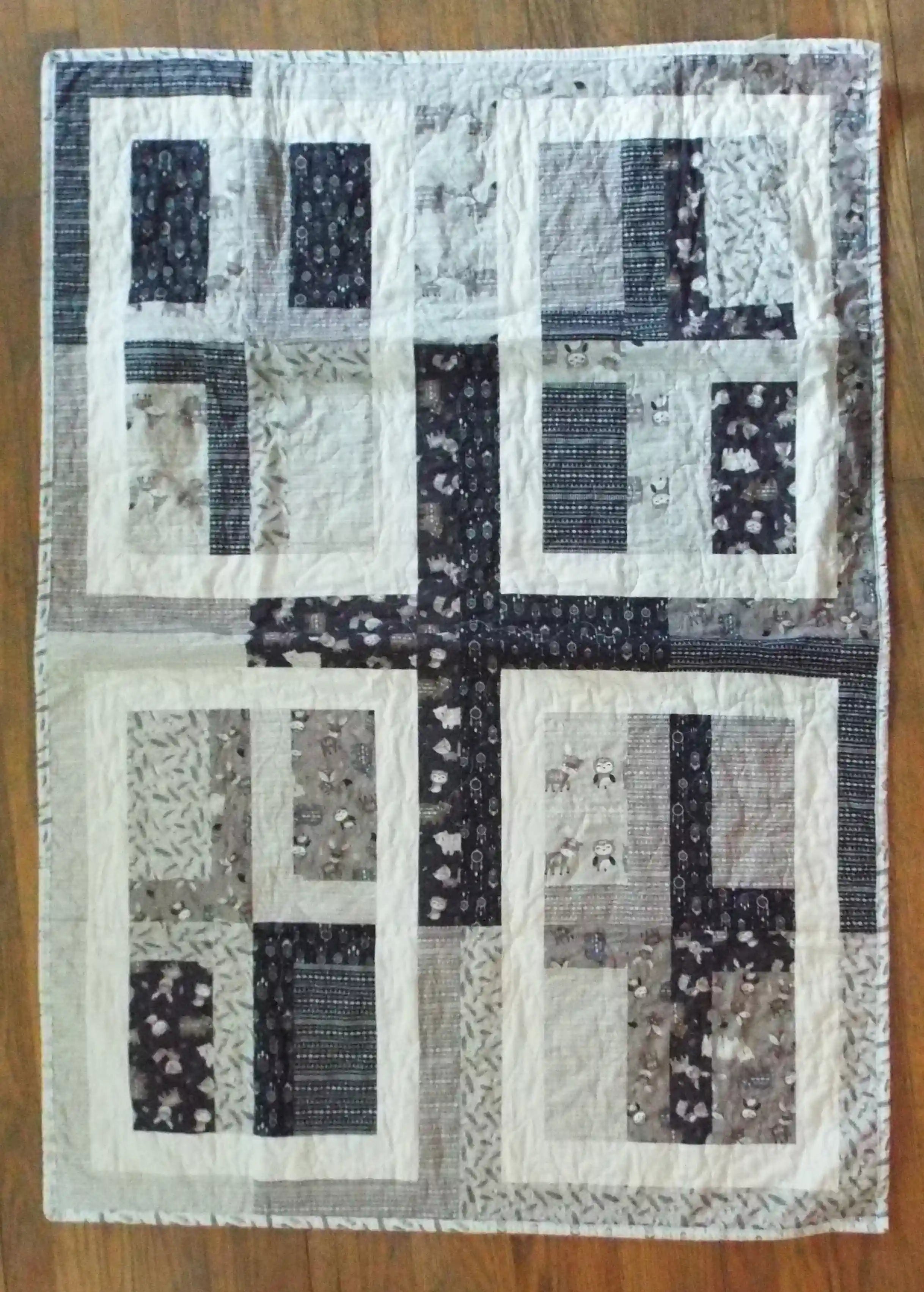 Flat lay of Little Framework Baby Quilt showing entire quilt.